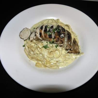 Chicken over pasta with white sauce